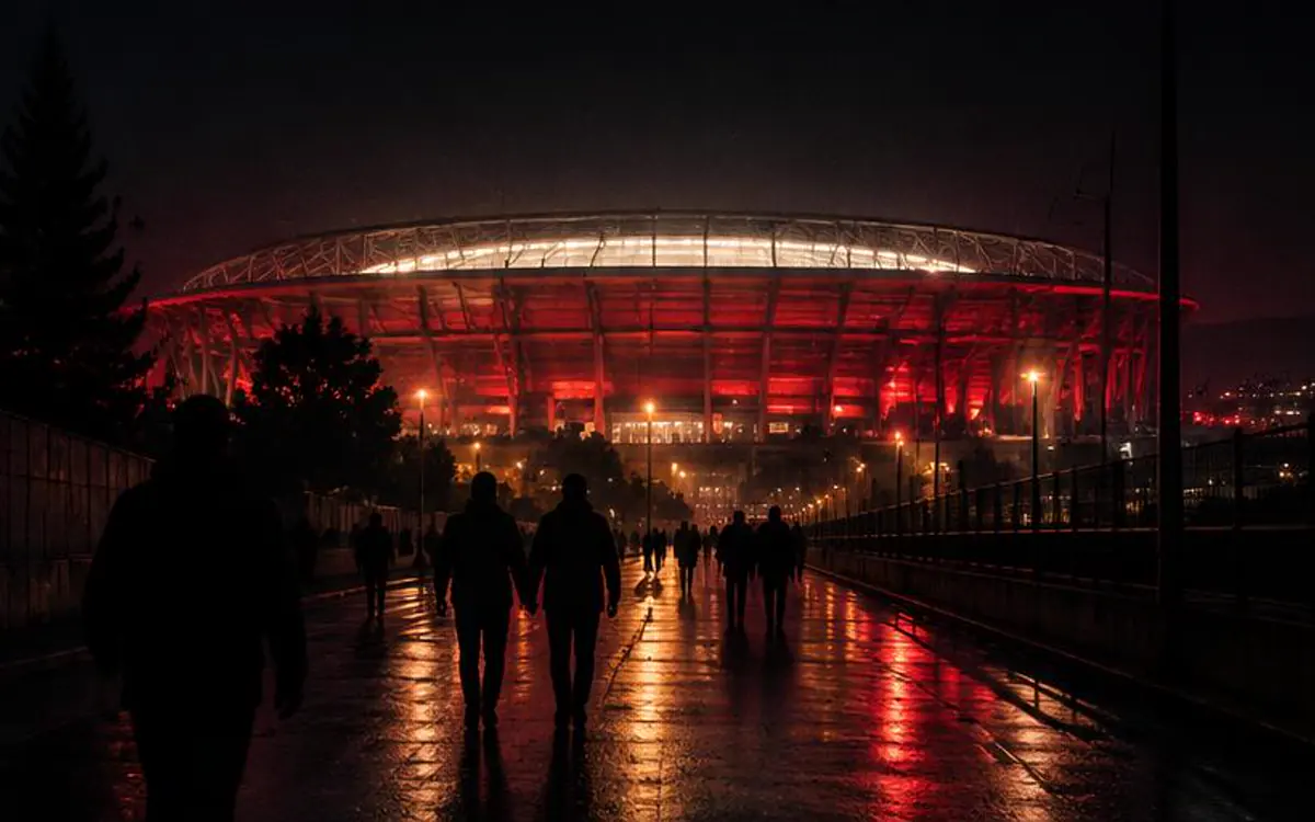 Personas caminando hacia un estadio urbano iluminado por la noche